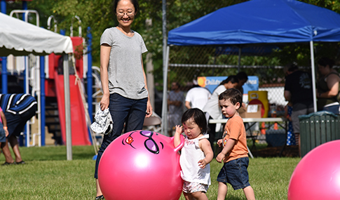 kids playing in park on bouncy balls