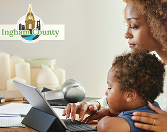 A woman and a child looking at a computer 