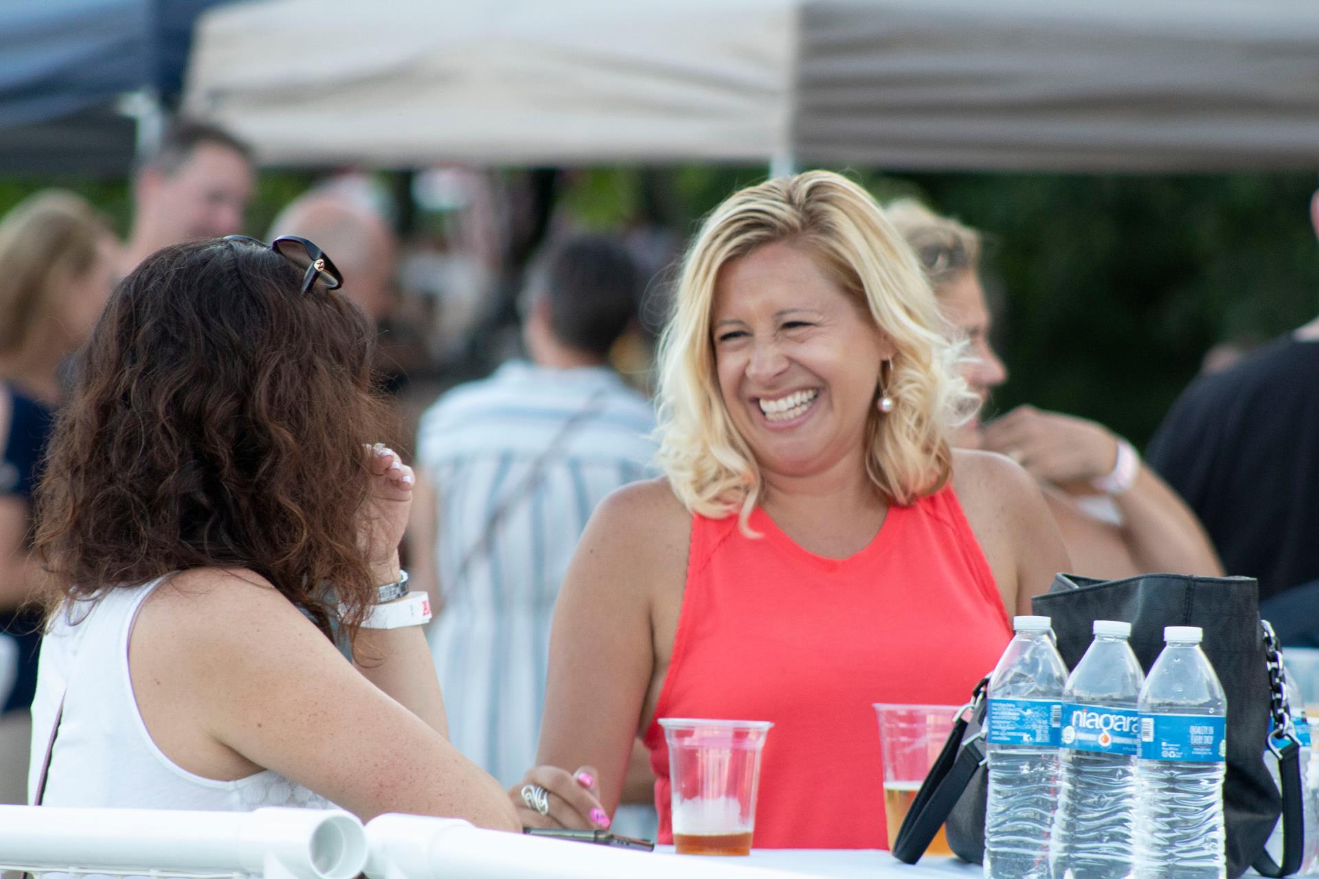 People at a table smiling with beverages 