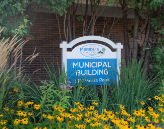 Photo of Meridian Township Municipal Building sign in the flowers