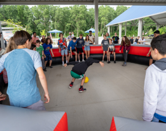 Photo of teens playing a game of gaga ball