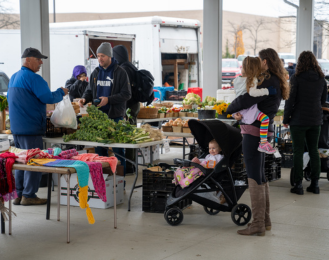 Photo of customers shopping at the outdoor Farmers' Market